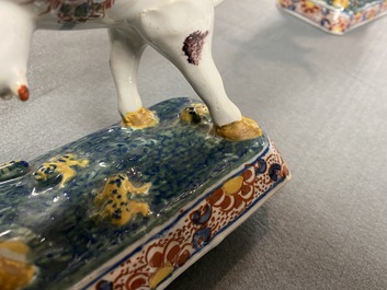 A pair of of polychrome Dutch Delft models of cows, 18th C.